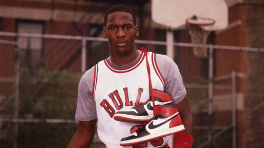 Young Jordan with Air Jordan 1 sneakers on his shoulder 