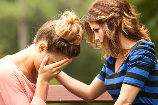 A girl is helping her friend to cope with a grief from the loss