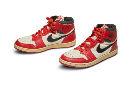 A photo of red and white Air Jordan 1 sneakers on white background