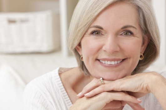 A good looking middle age woman smiling and looking into the camera