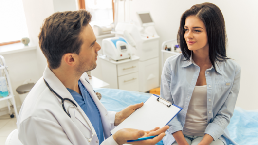 A doctor from a walk-in clinic consulting girl  