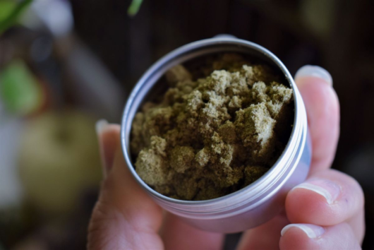 A close up picture of cbd hemp powder in a jar
