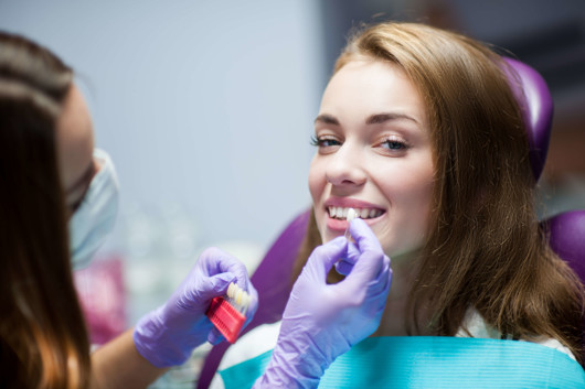 A doctor is selecting dental crowns for the girl