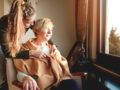 A young lady is taking care of an old woman in a hospice