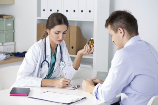 A doctor is prescribing medication to the patient