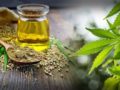 CBD oil, hemp seeds and hemp leaves on the wooden background