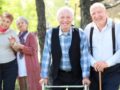 Old people are walking in the park and look happy.