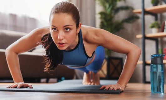 Girl is doing push ups at home