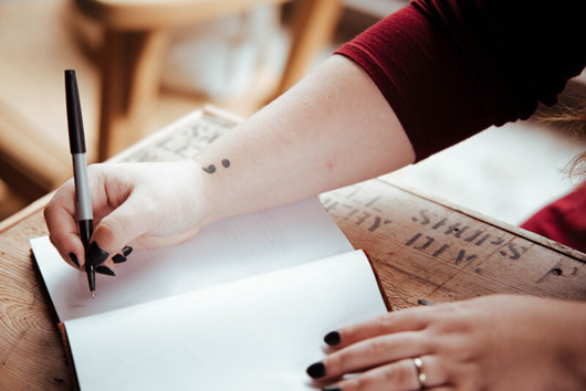 Girl is planning to write something in her empty notebook