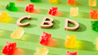 CBD on a green background and gelatin in the form of bears.