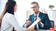 Health insurance agent is asking the girl to sign the paper