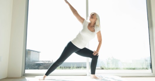 Woman is doing yoga in the room