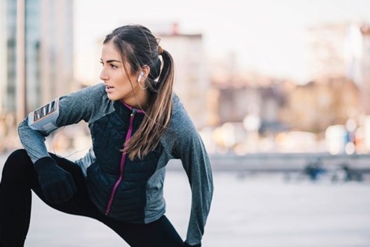 An athlete girl is working out outside