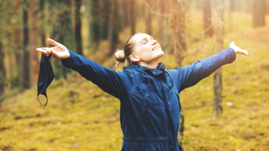 A girl in the forest is showing how happy and healthy she is