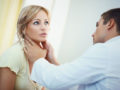 the doctor is checking the woman's face after skin cancer reconstruction surgery