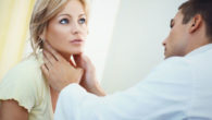 the doctor is checking the woman's face after skin cancer reconstruction surgery