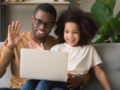 black dad with kid daughter. They are doing speech teletherapy