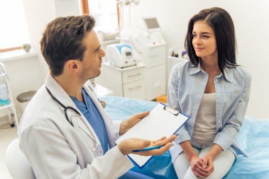 A young girl is consulting a plastic surgeon before the operation