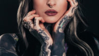 A close picture of a lady with tattooed arms and hands. Risks of tattoos