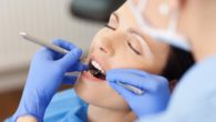 The woman is under dental sedation while the doctor is checking her teeth