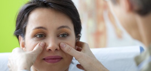 A doctor is doing check up to a woman before Comparison of female nose, before and after scarless rhinoplasty