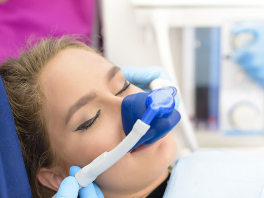 Girl is at the dentist's under dental sedation