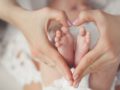 A close up picture of a baby feet in heart made hands