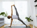 Woman practicing yoga at home