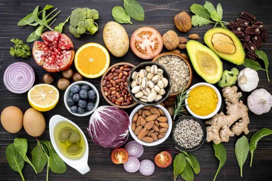 Different fruits and vegetables are lying on the wooden table