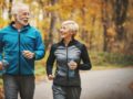 A senior couple is exercising in the park in autumn