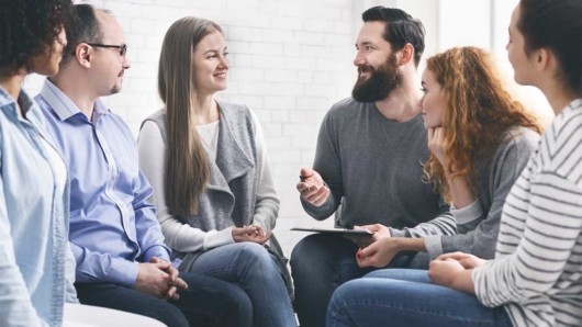 Impatient rehab group of people talking and smiling