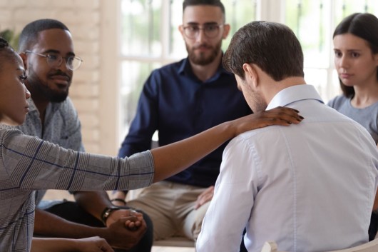 People at the addiction center are talking to a guy