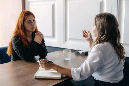 The therapist is talking to the girl with bipolar disorder