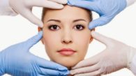 A close up image of a woman with hands in rubber gloves