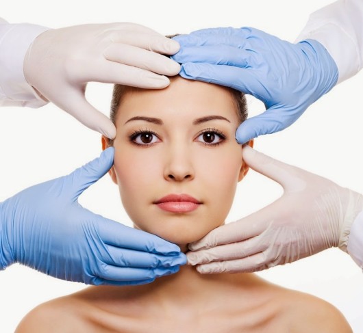 A close up image of a woman with hands in rubber gloves