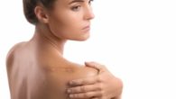 A girl on white background with a big scar on her shoulder