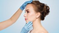 A doctor is checking girl's nose after the rhinoplasty