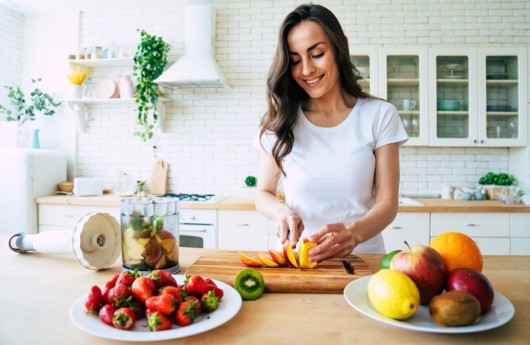 A girl is preparing healthy meal after liposuction procedure