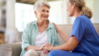 A doctor is talking to a senior lady in light green shirt