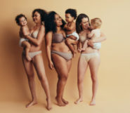 A young mommies with babies on the beige background