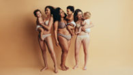 A young mommies with babies on the beige background