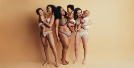 A young mommies with babies on the beige background