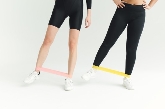 Two women training with resistance bands Two women training with resistance bands